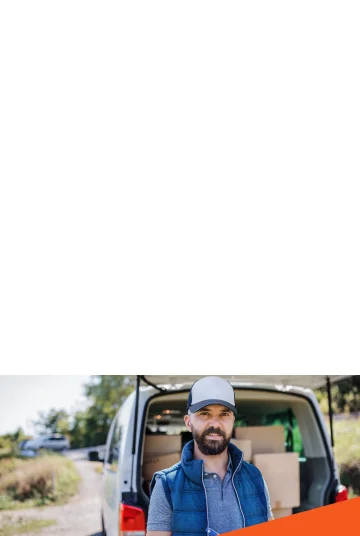 Photograph of man in front of his Commercial Auto.