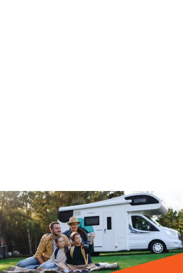 Family taking a selfie in front of their RV.