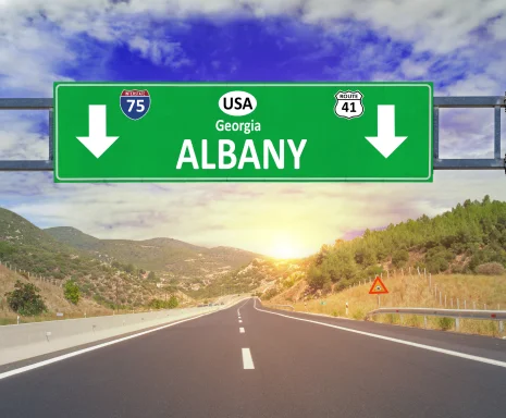US city Albany road sign on highway, cheap car insurance in Albany, Georgia.