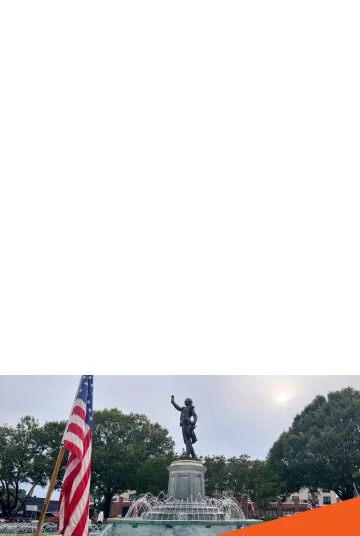 Historic Lafayette Fountain in downtown Lagrange, Georgia with a United States flag on Independence Day: Cheap car insurance in The Peach State