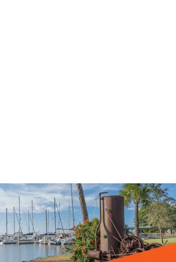 Old hoist motor with a beautiful view of a shipyard in the background in Brunswick, GA. Cheap car insurance in Georgia.