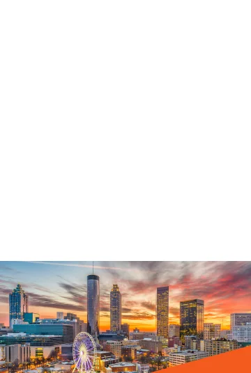 Skyline, cityscape, sunrise or sunset of downtown Atlanta, Georgia with ferris wheel: Cheap car insurance in The Peach State. Piedmont Park skyline in Dogwood City in autumn. View of a lake, downtown Atlanta, and reflection of trees and buildings in the water. Cheap car insurance in Georgia.